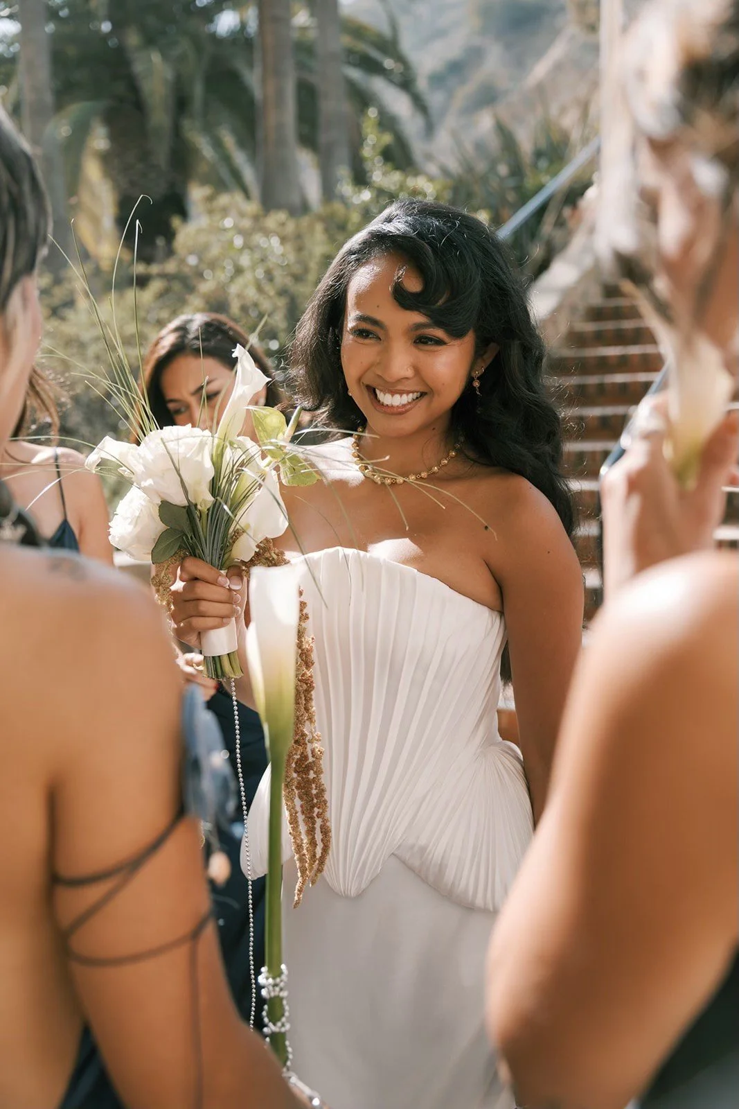 Bride holding a sculptural white bouquet