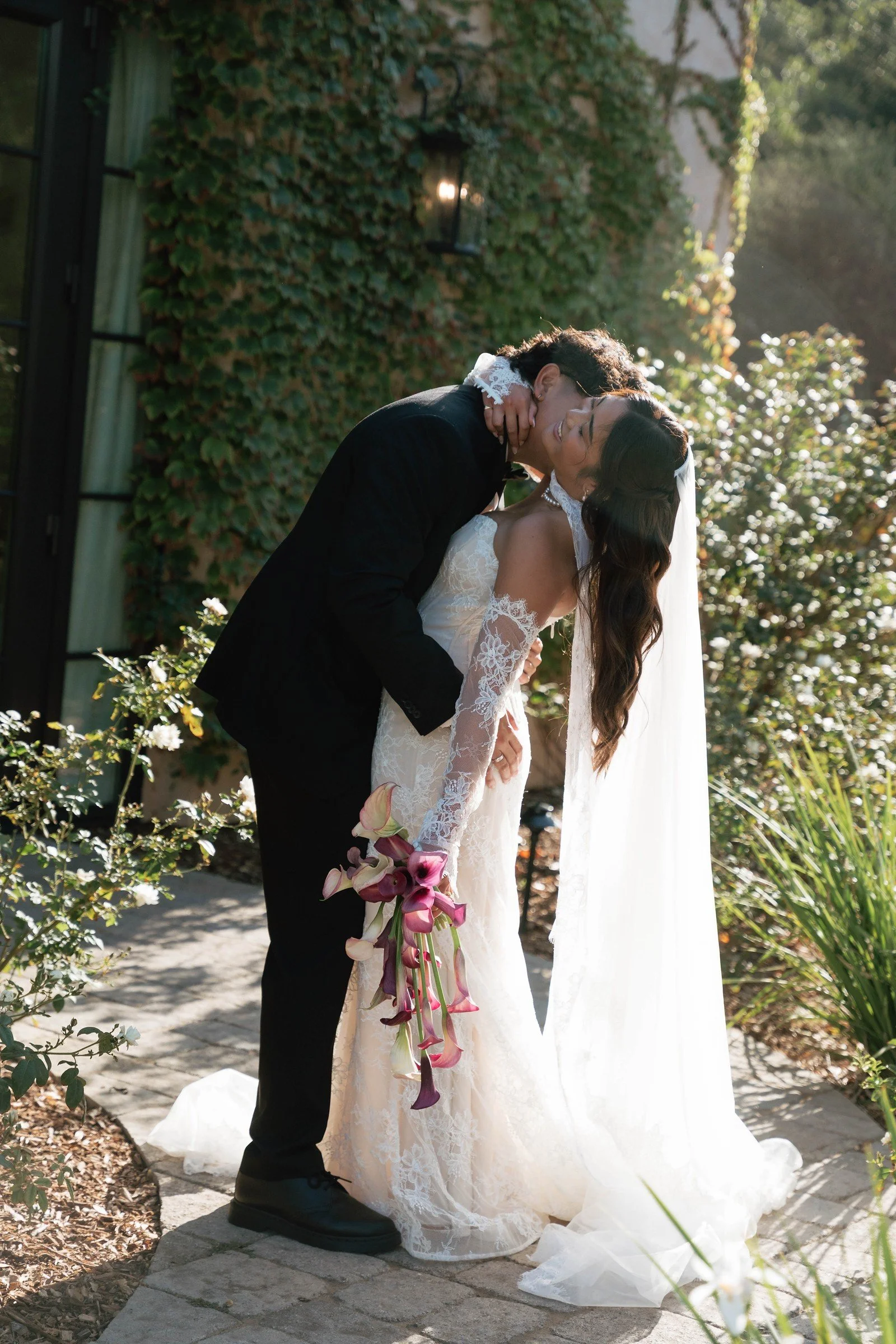 Couple embracing beneath garden trees