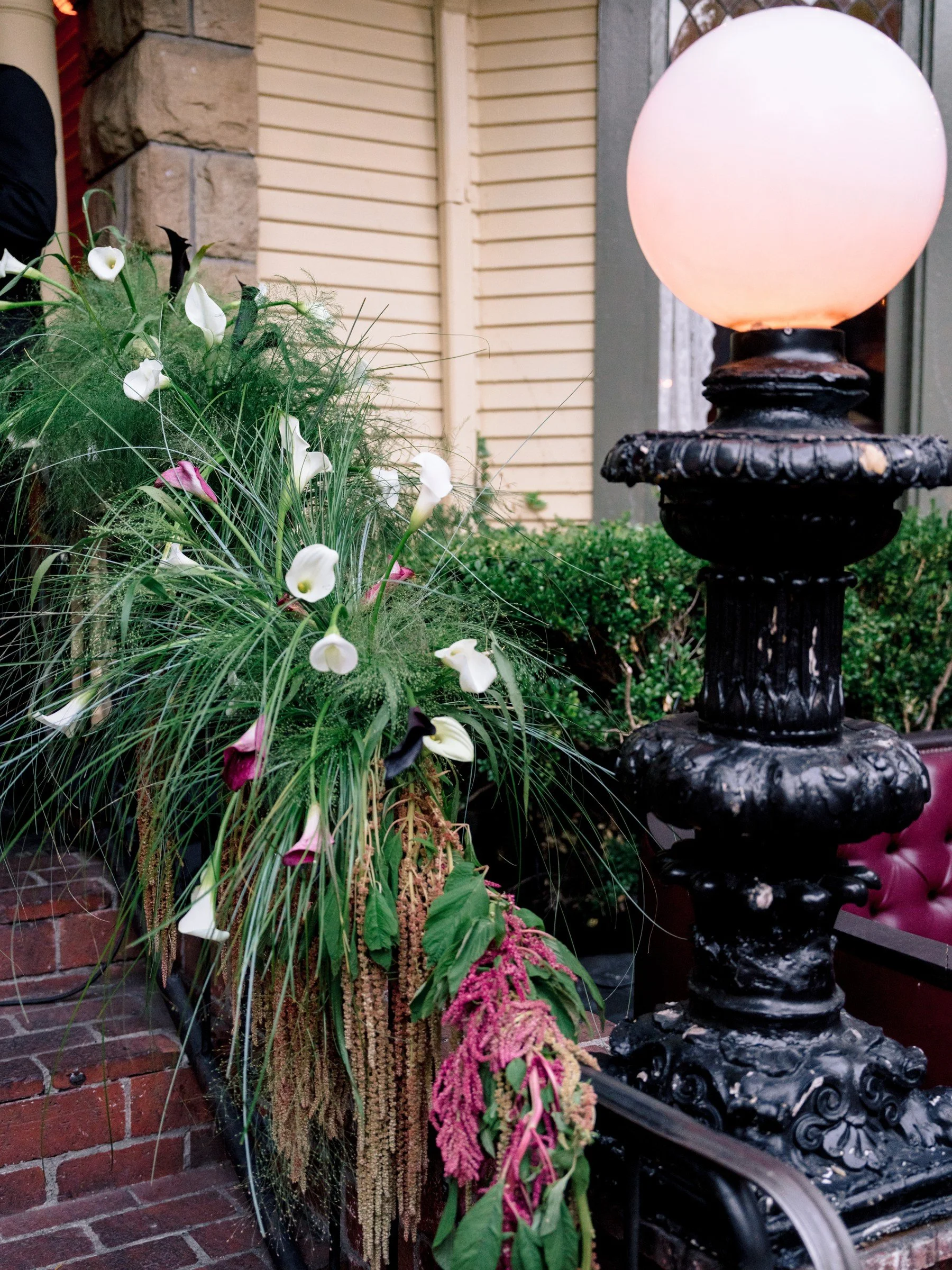 Sculptural flowers beside a glowing garden lamp