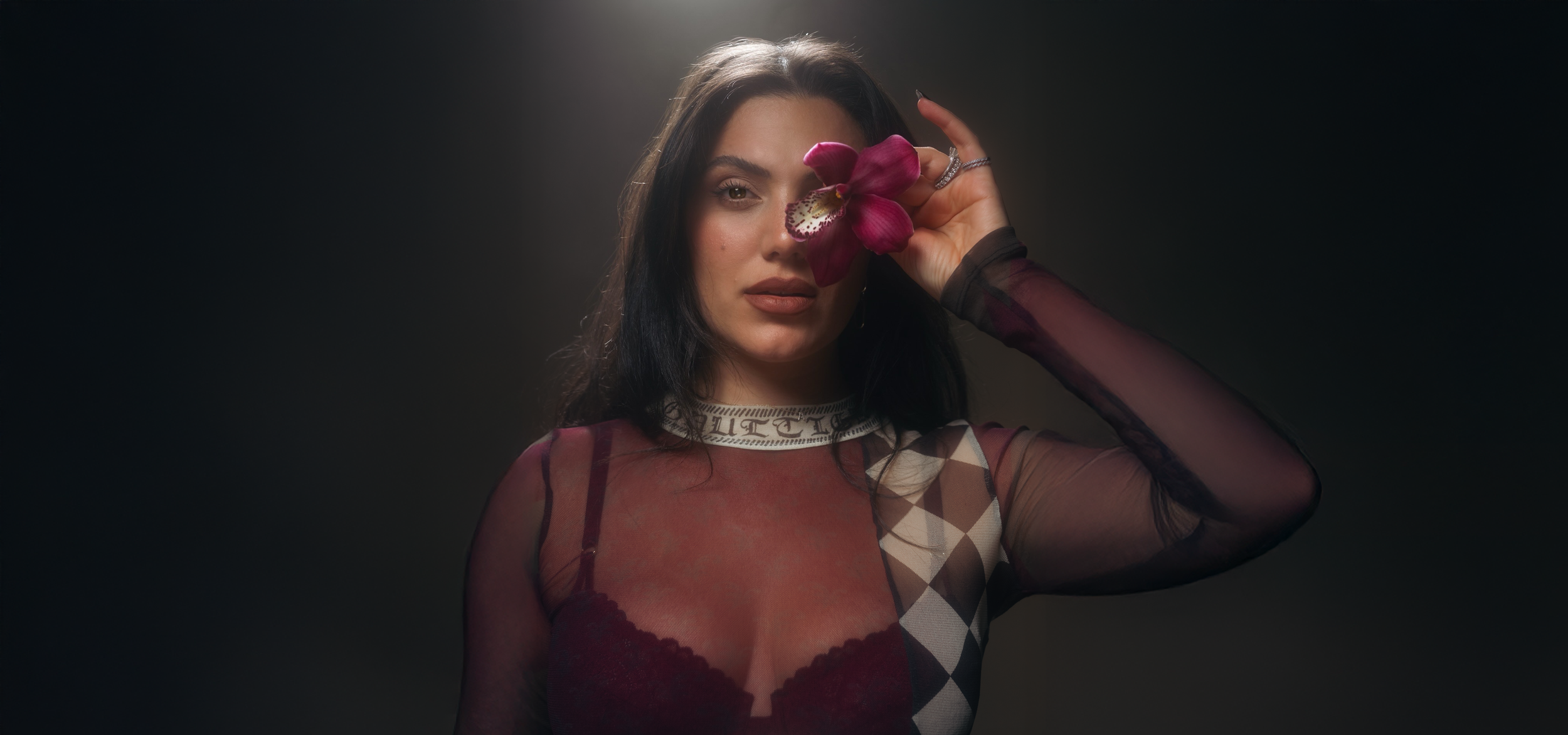 Arpy, founder of Haus of Gather, holding a flower