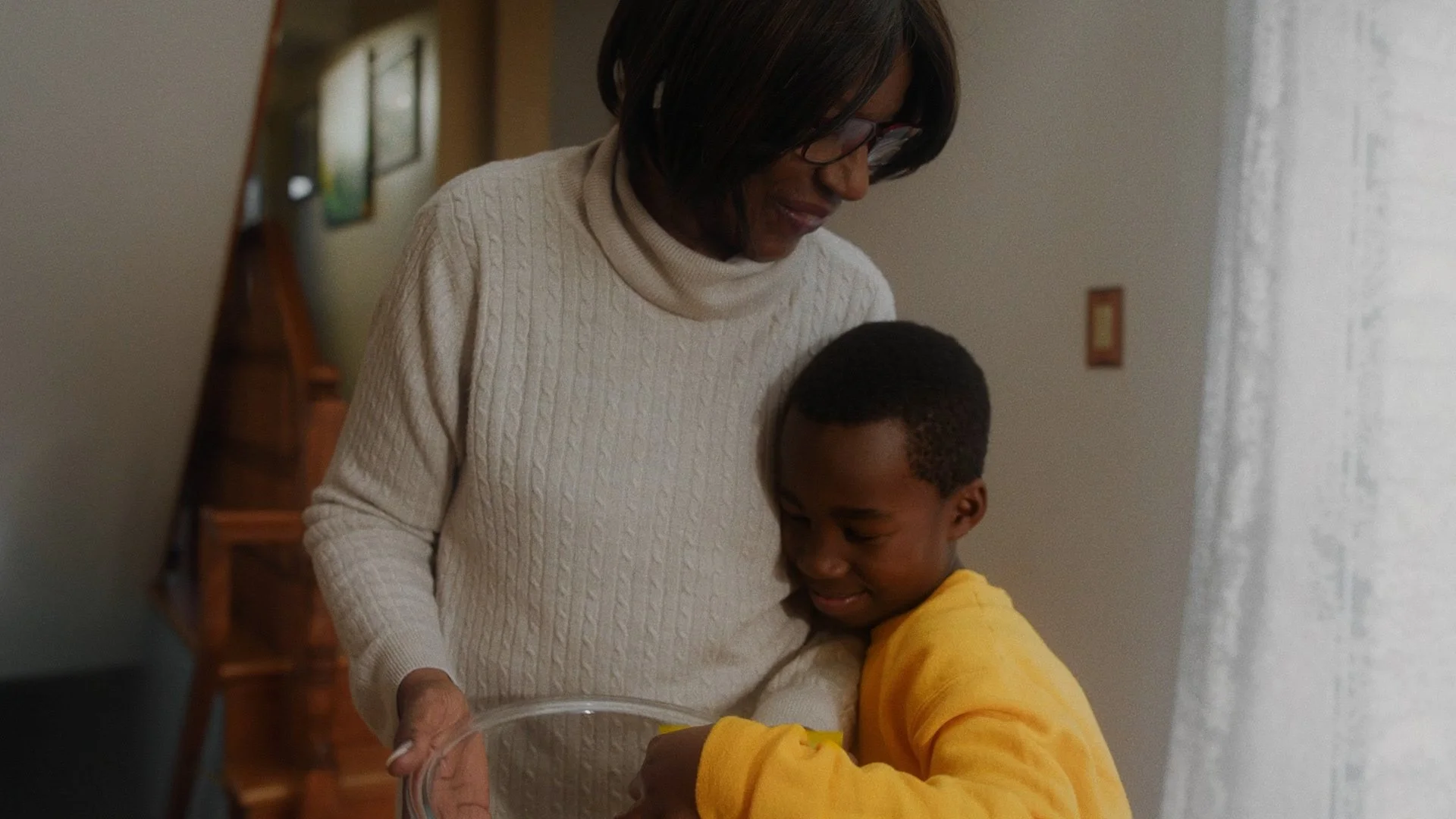 A grandmother shares a hug with her grandson in a Lays Chips commercial video