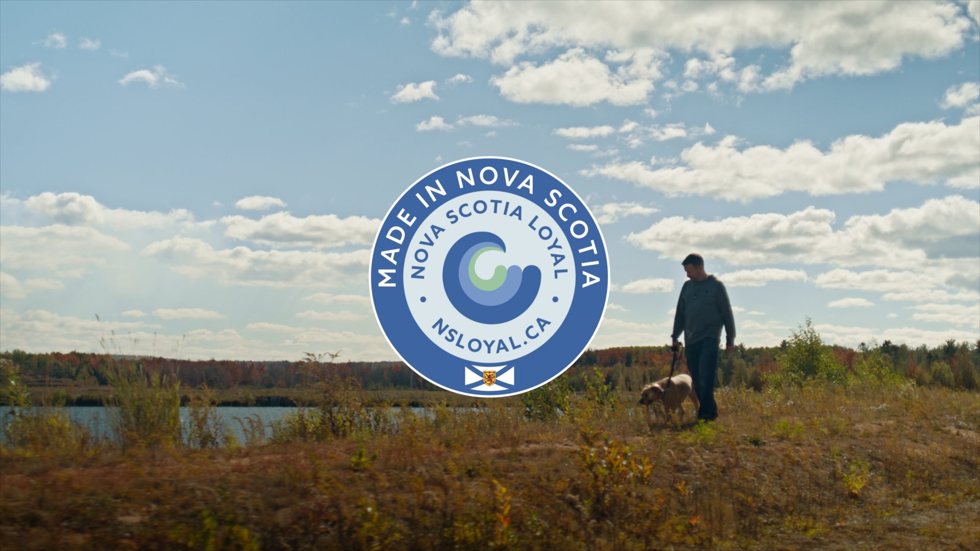 Man running up sand dune on Prince Edward Island from tourism commercial