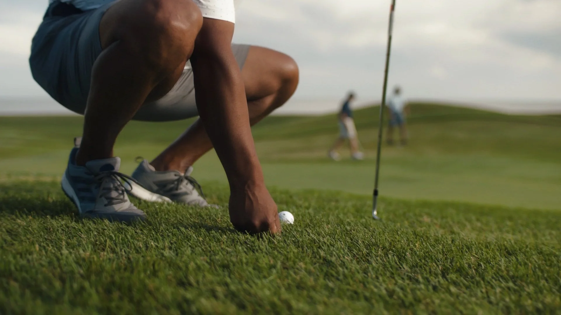Man lines up tee at Crow Bush golf course on Prince Edward Island from tourism commercial