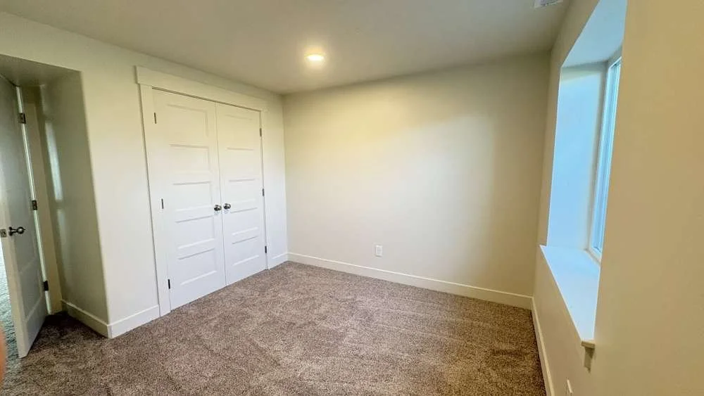 Bedroom with a full closet, Cache Valley project by Corbridge Construction