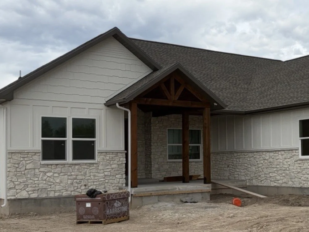 Stone veneer wainscot and board-and-batten siding on a custom home in Smithfield, Utah