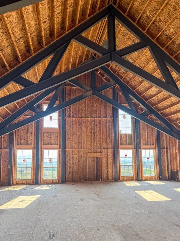 Exposed timber-frame trusses built by Corbridge Construction in Hyde Park, Utah