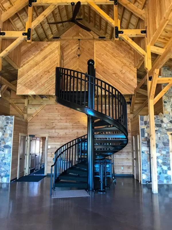 Timber-frame commercial interior with spiral stair in Hyde Park, Utah by Corbridge Construction