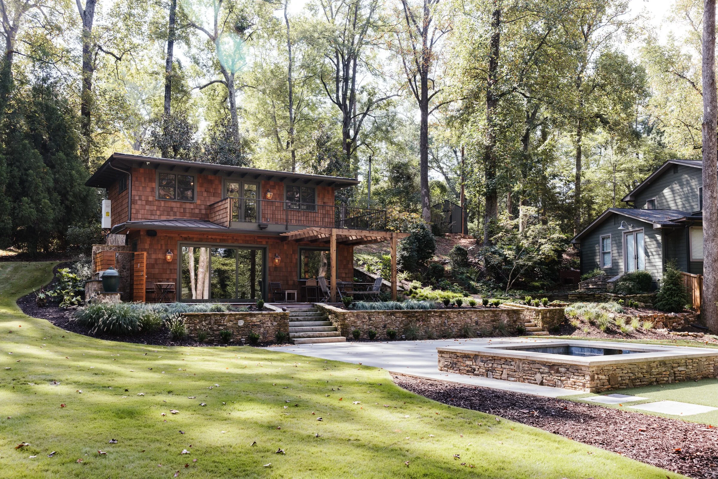 Wooded Athens residence overlooking a terraced lawn, pool and spa