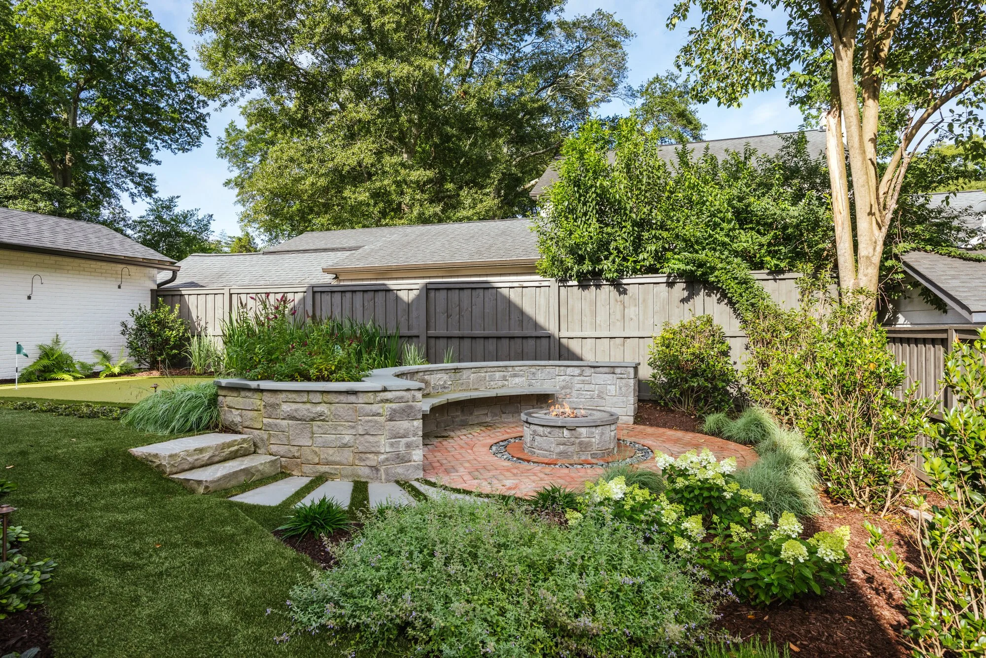 Fire terrace framed by planting and mature trees