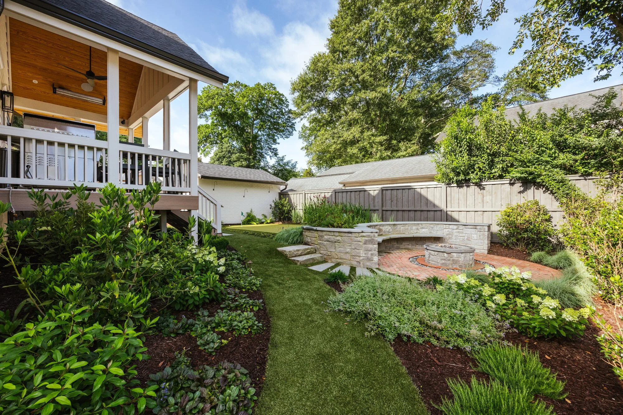 Curved fire terrace framed by layered planting