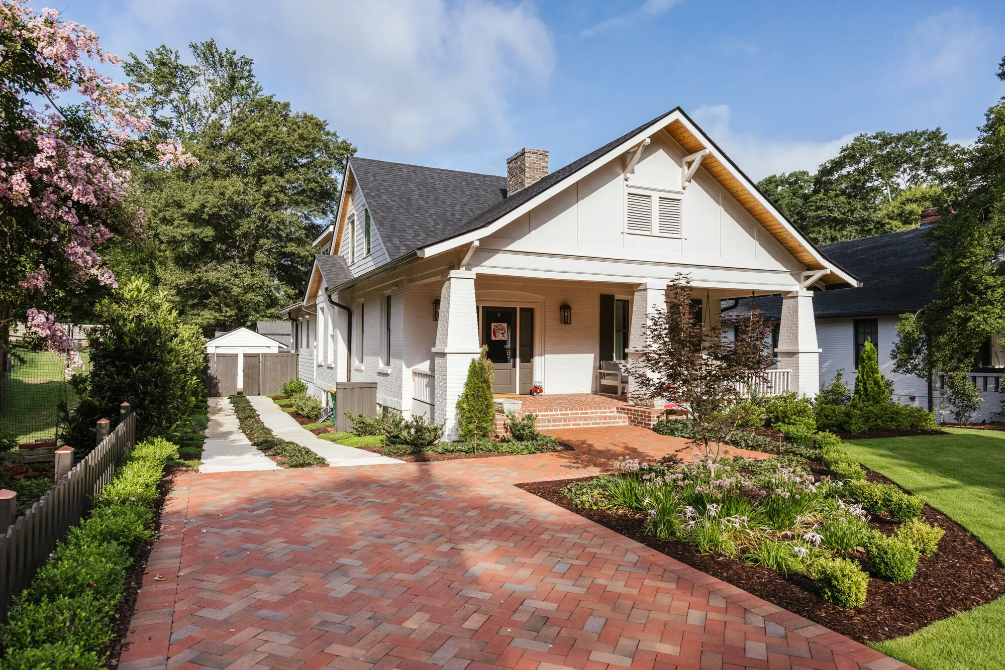 Brick drive leading toward the white bungalow in Five Points