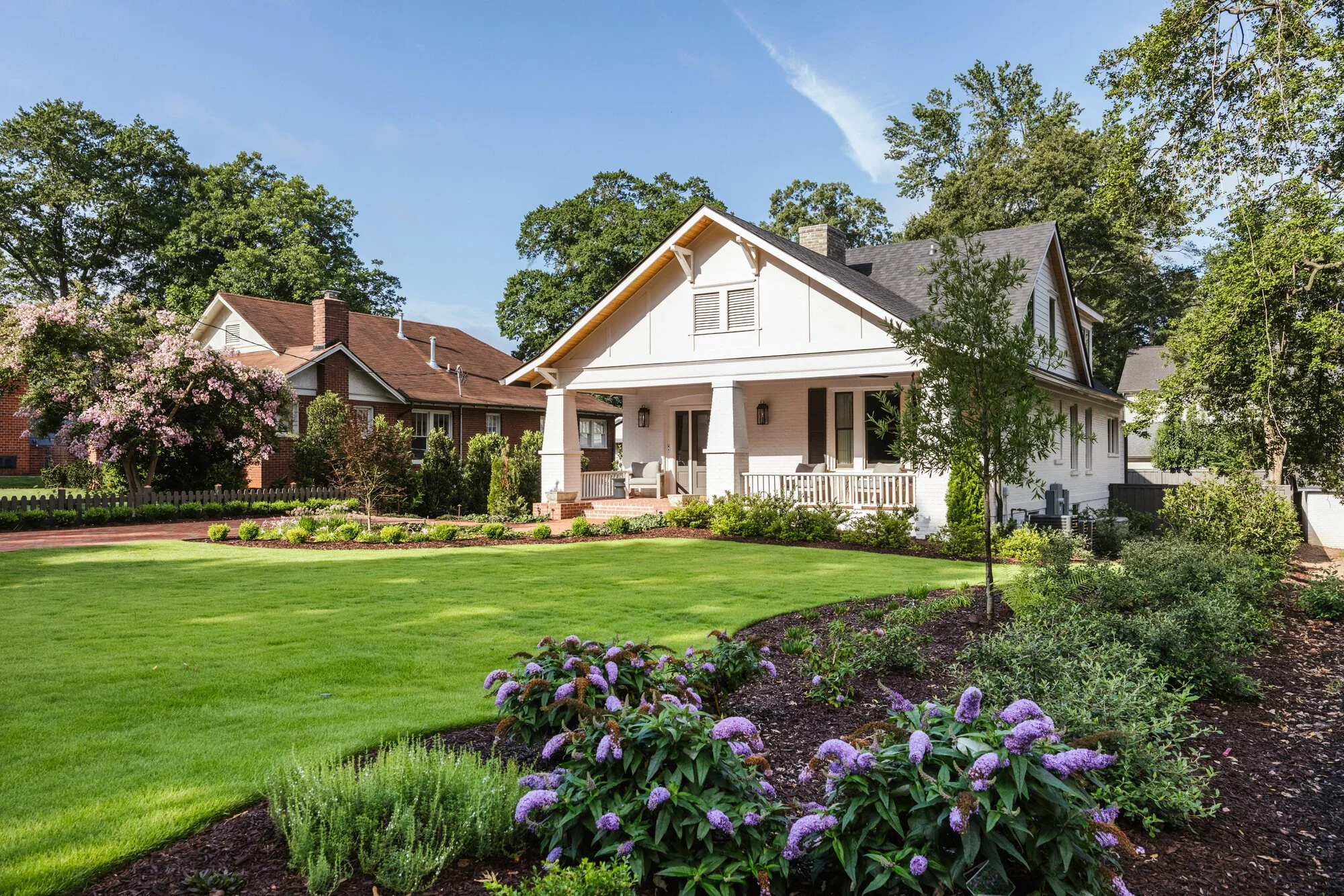 Open front lawn and flowering borders at the Cherokee residence