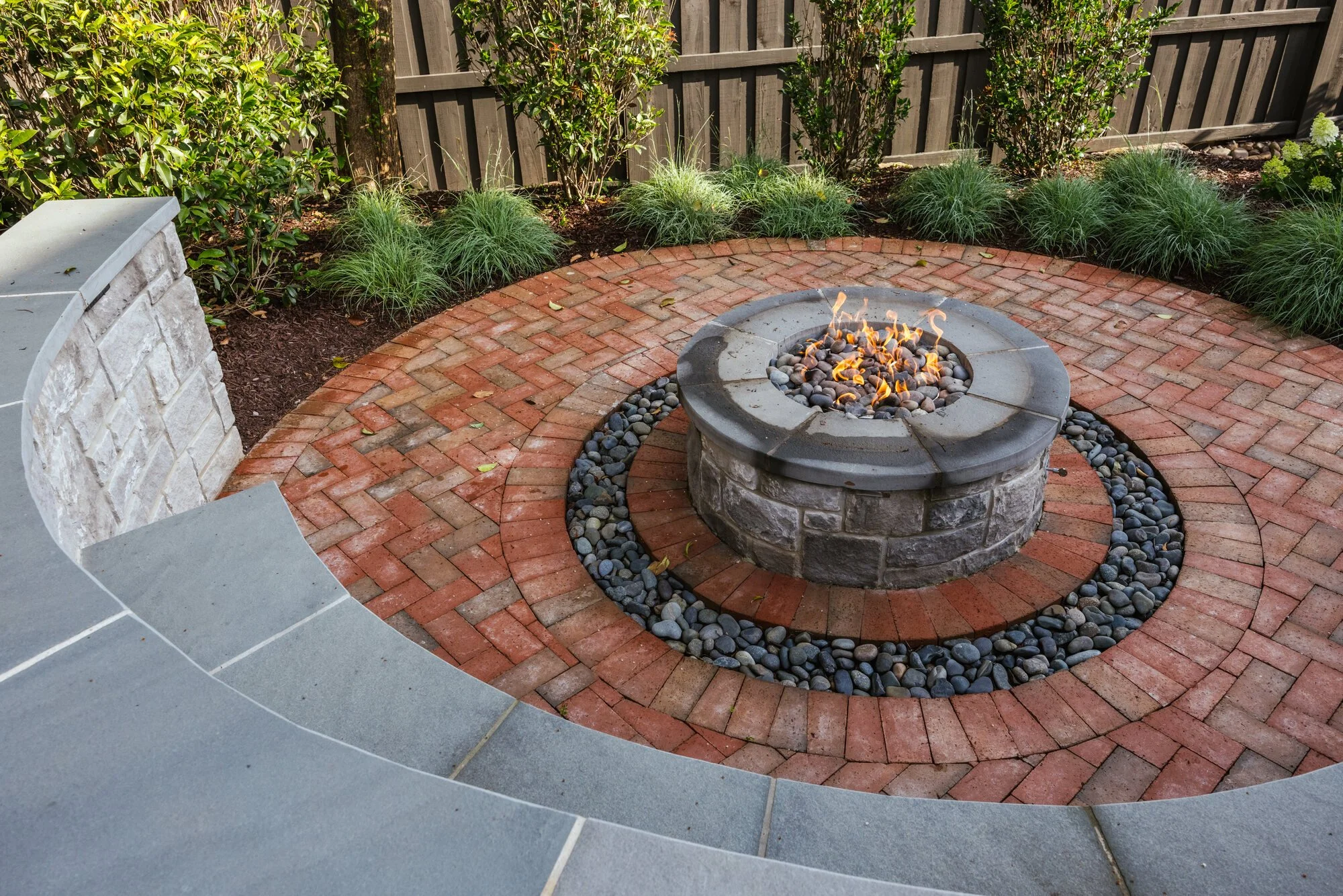 Round gas fire feature set within patterned brick