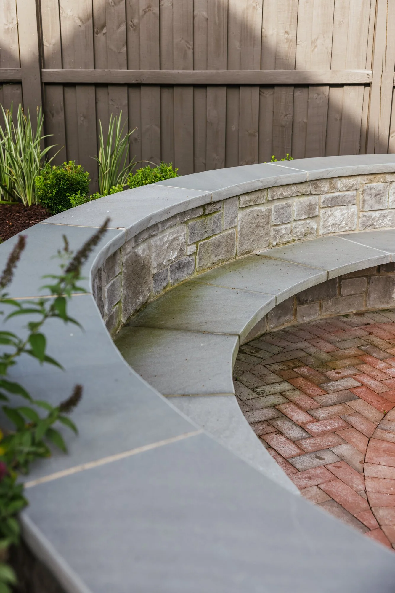 Curved bluestone-capped seat wall detail