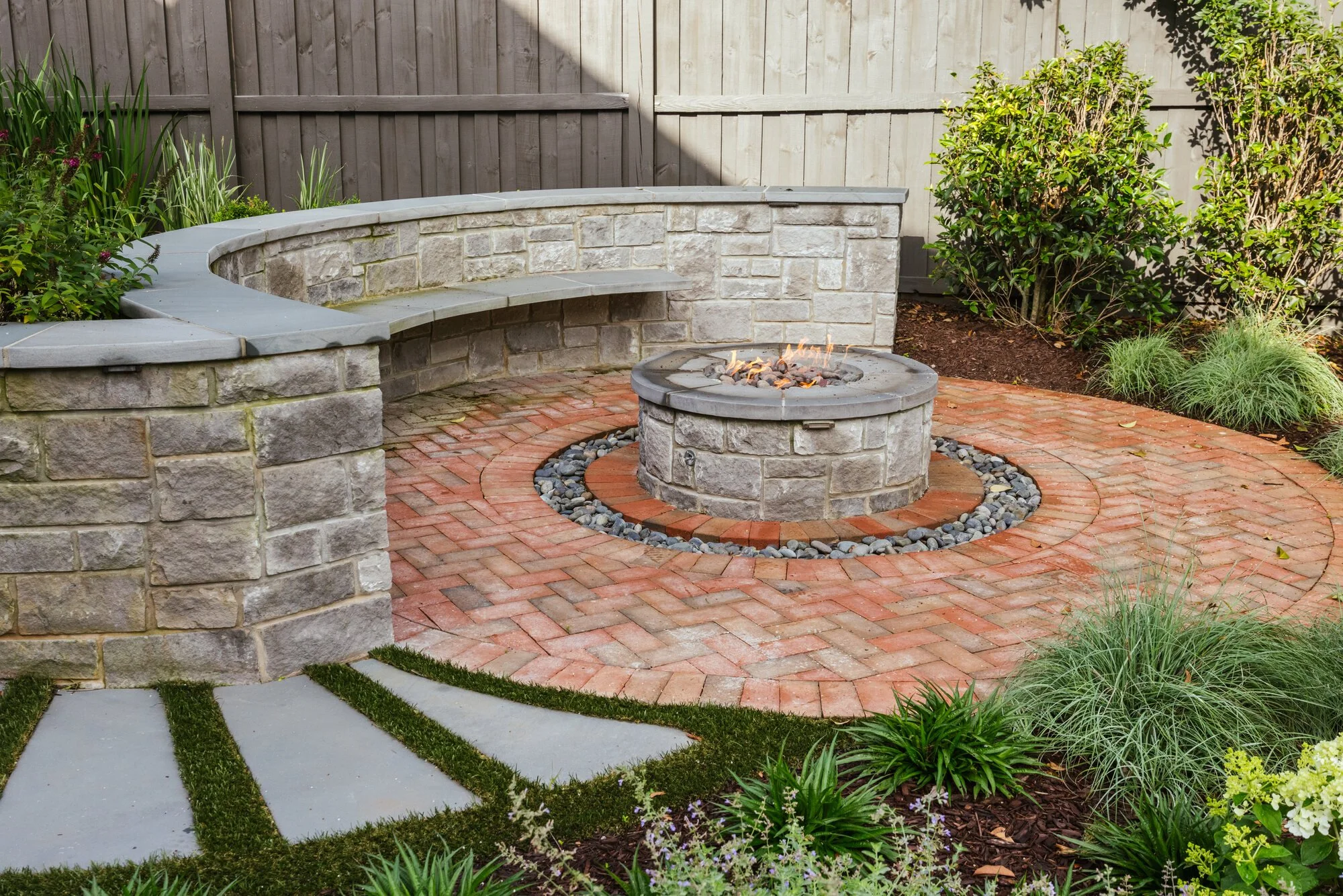Bluestone-capped seat wall and radial brick terrace