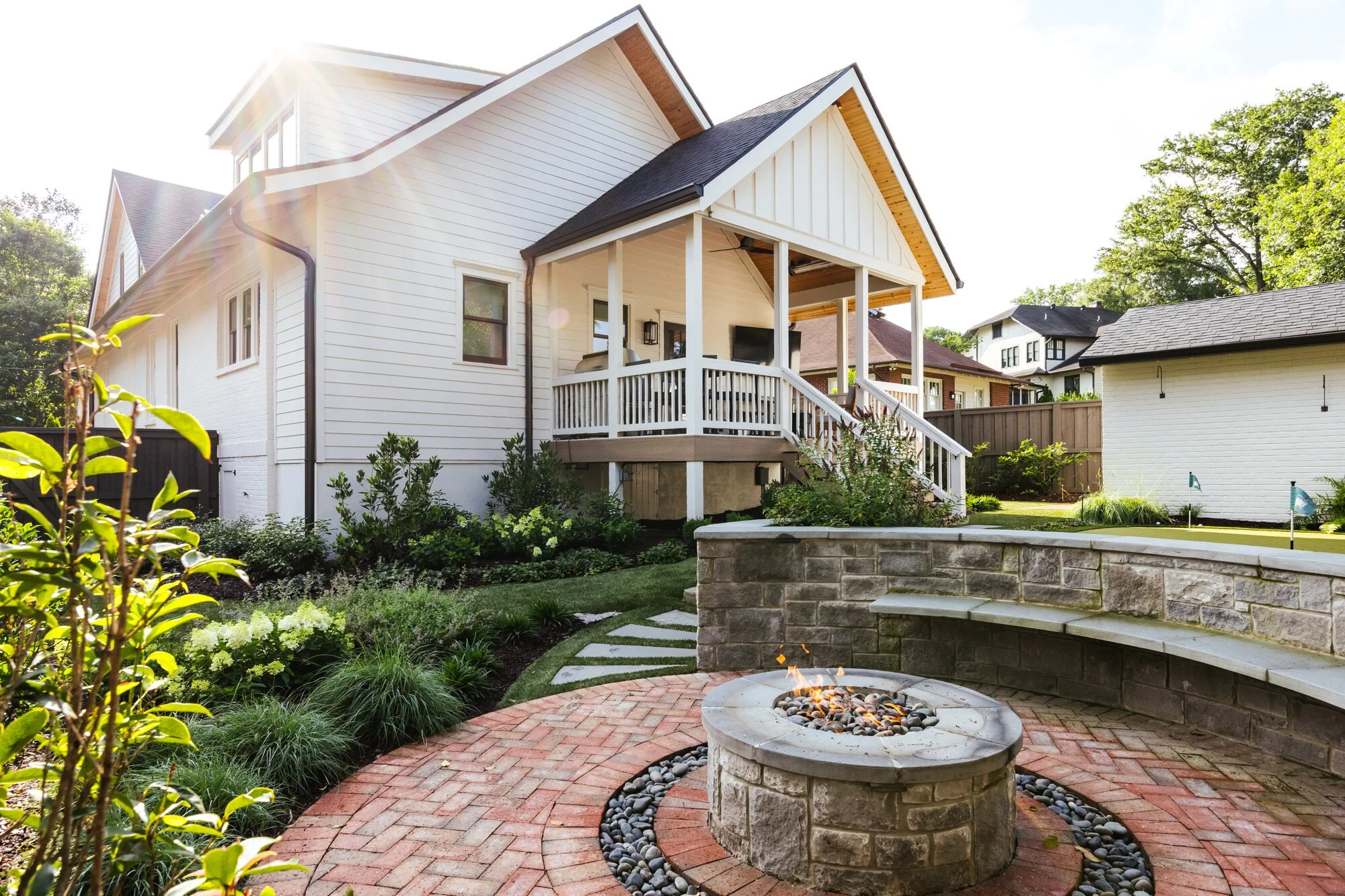 Rear porch overlooking the curved stone fire terrace