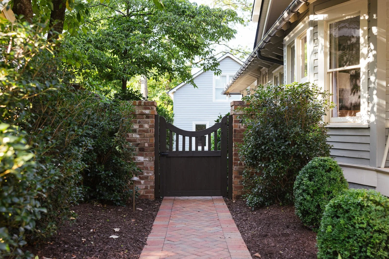 Layered shade planting beside the front porch