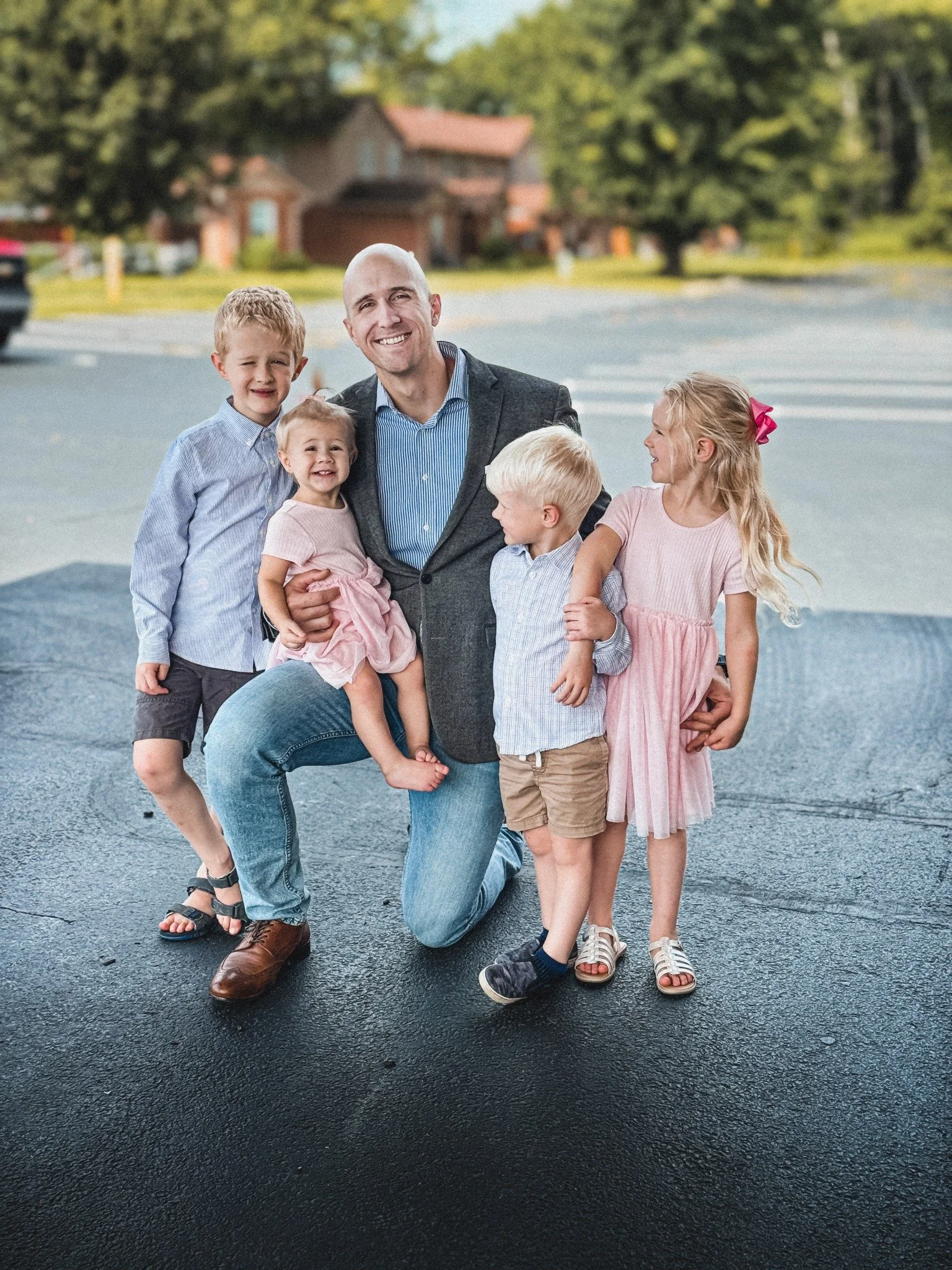 Cody smiling with his four children