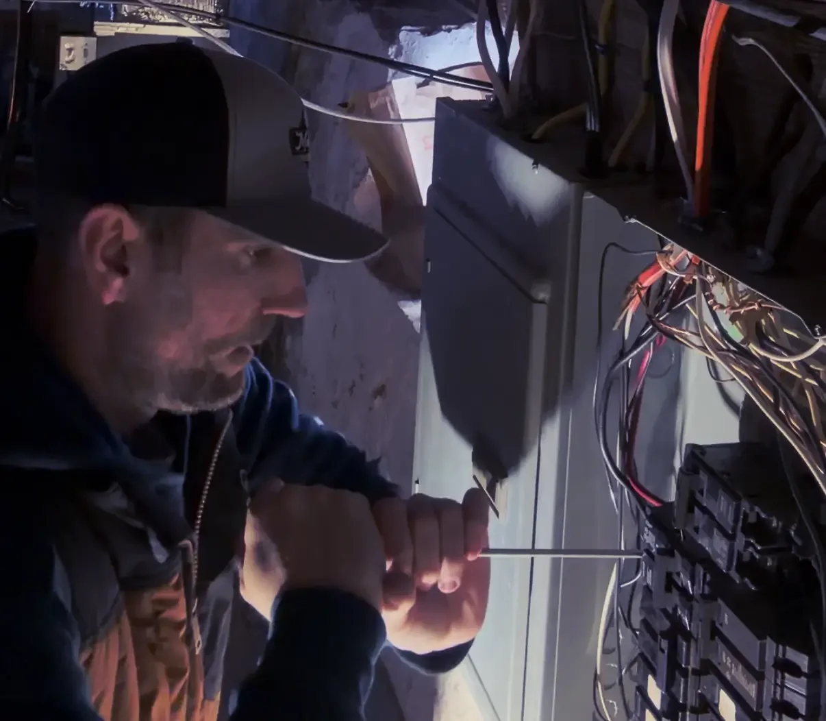 Emergency electrician troubleshooting an electrical panel in Rhode Island
