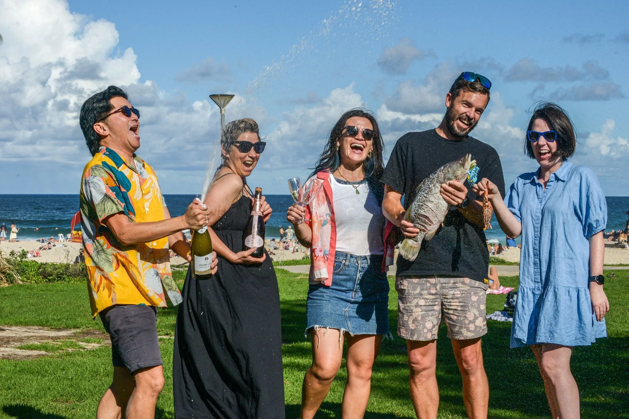 Guests enjoying the Sydney Beach BBQ Experience with fresh seafood, drinks and beachside hosting in Sydney