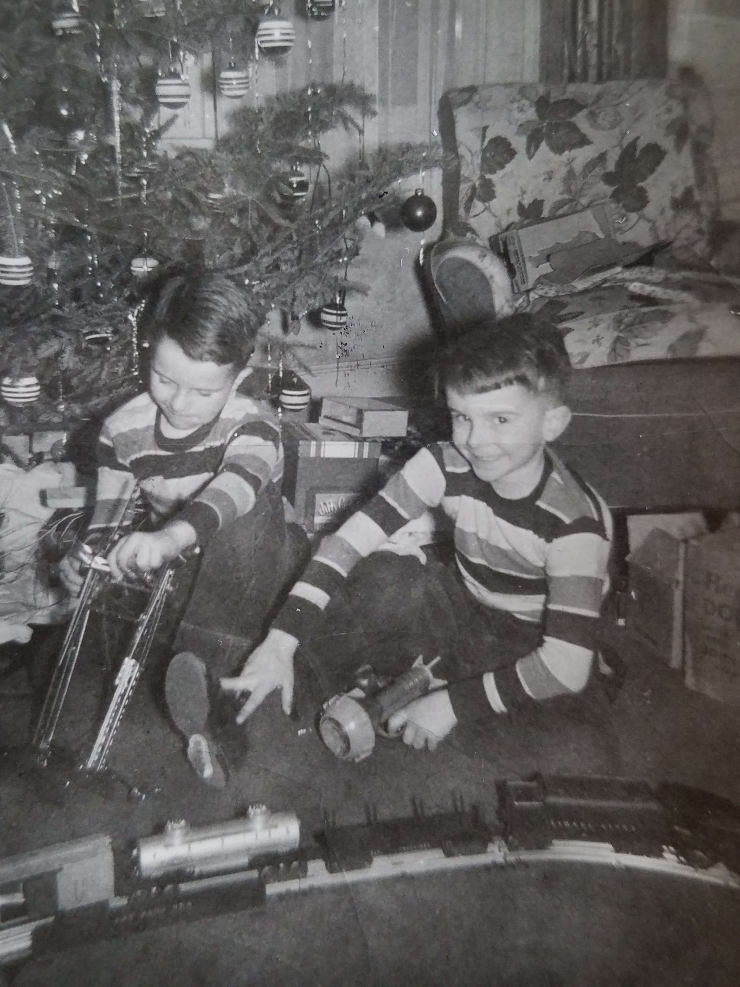 The twins with toys under the Christmas tree