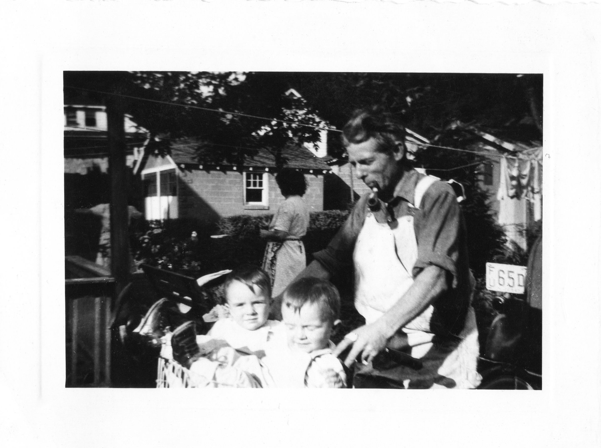 Miles Sr. with the twins outside, pipe in mouth
