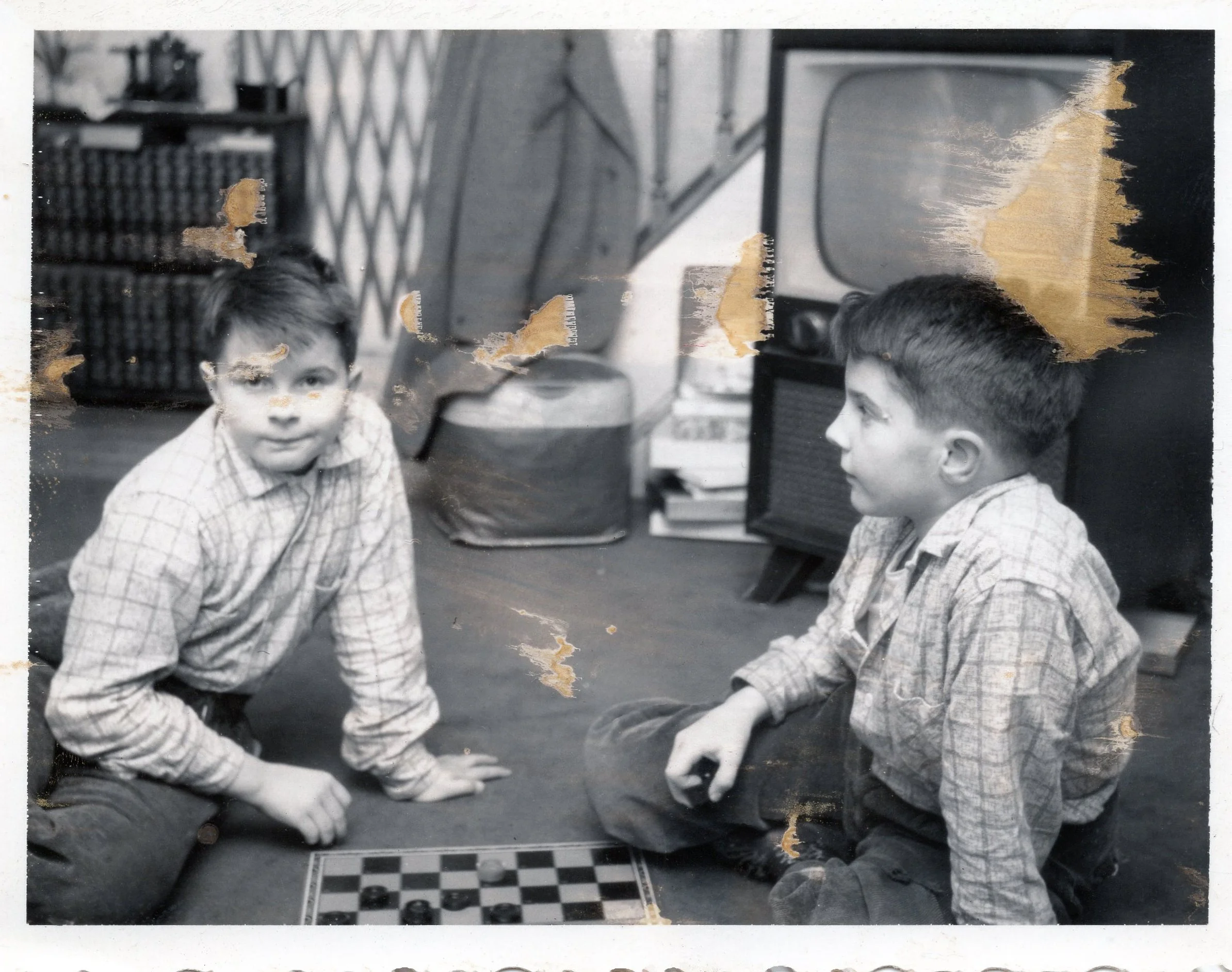The twins playing checkers by the TV