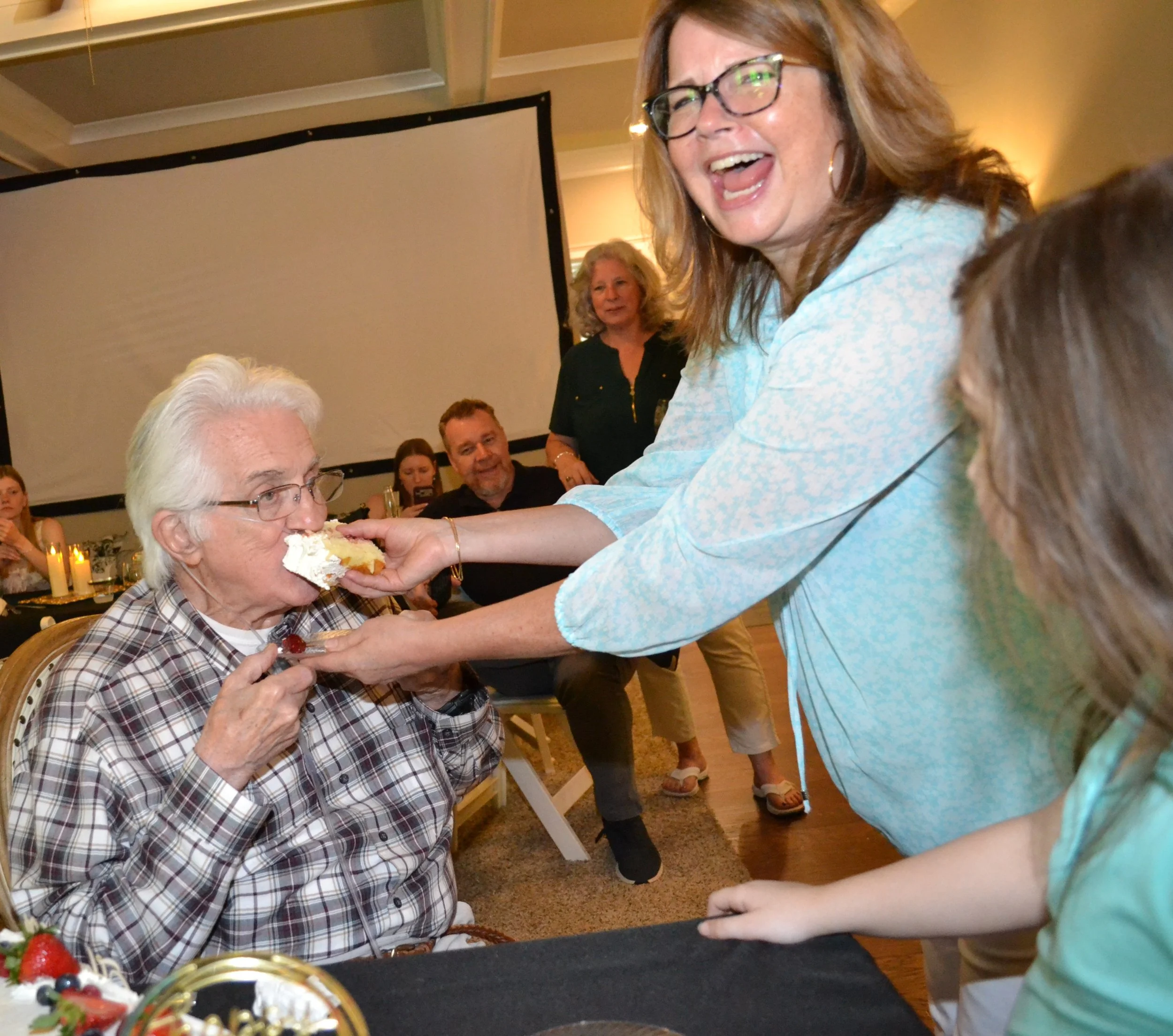 Colleen feeding cake to her father Miles