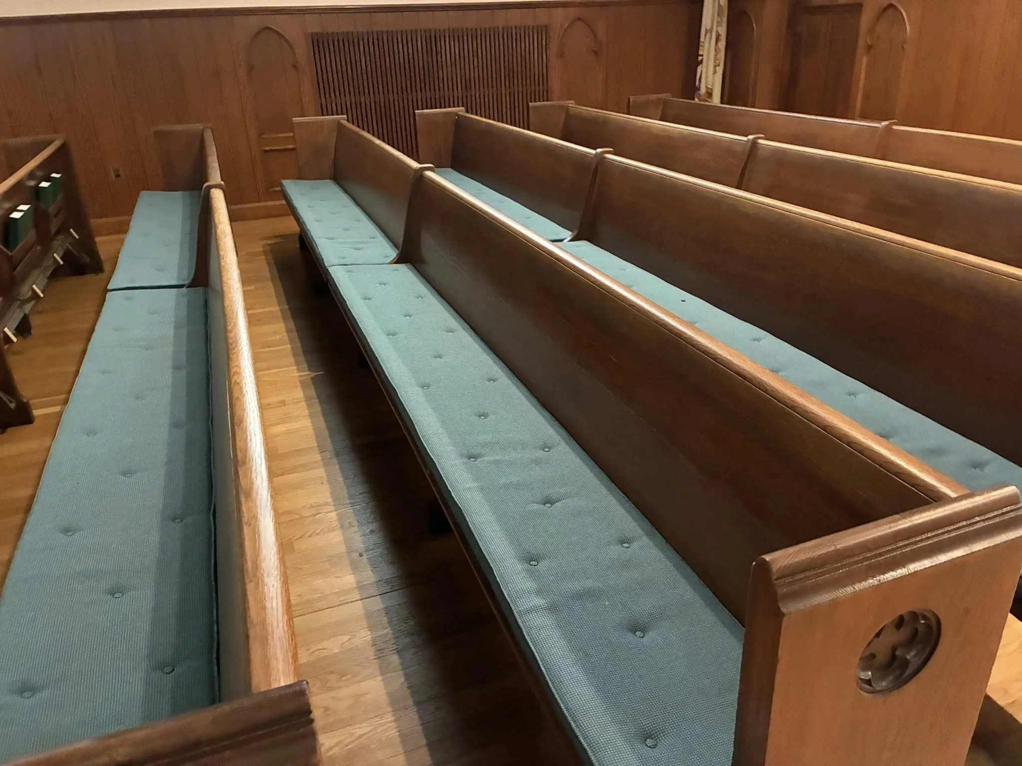 Original oak pews with teal cushions at St. Aloysius Church