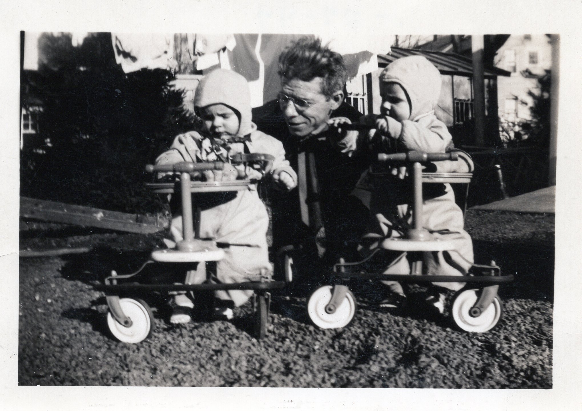 Father Miles with the twins in matching walkers