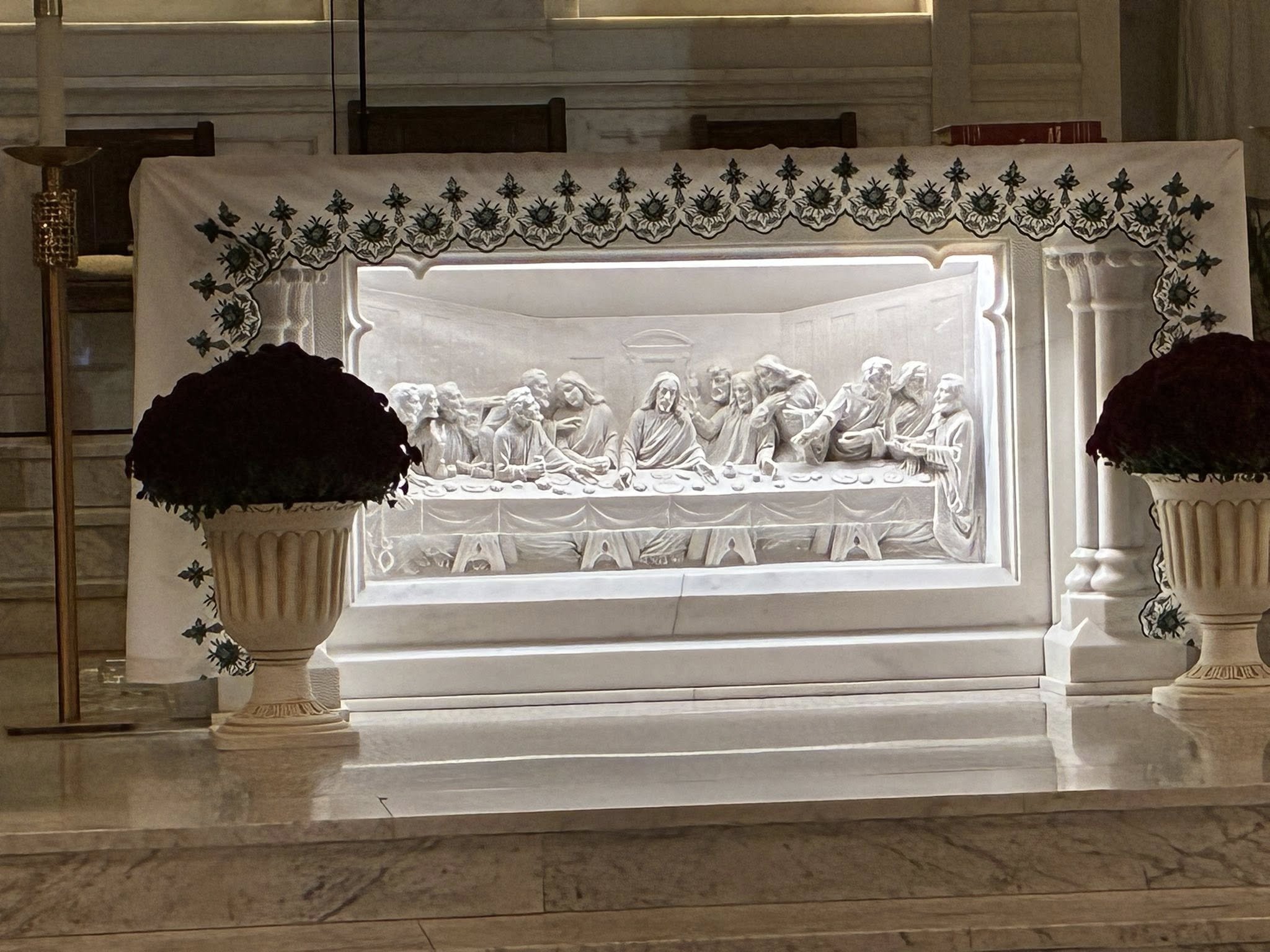 Main altar at St. Aloysius Church showing Last Supper relief in white Carrara marble