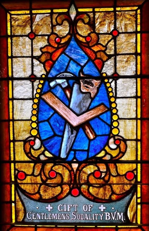 Stained glass window depicting carpenter's tools, Gift of Gentlemens Sodality B.V.M.