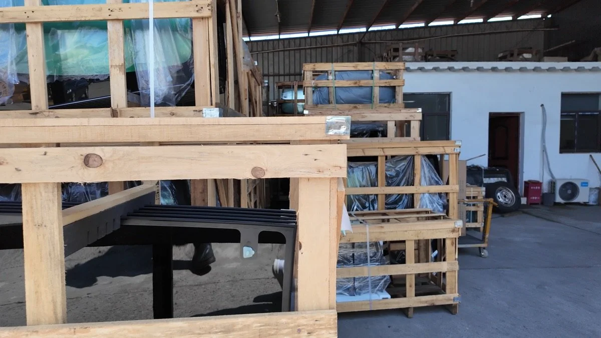 Large automotive glass held in wooden racks in a handling and supply environment