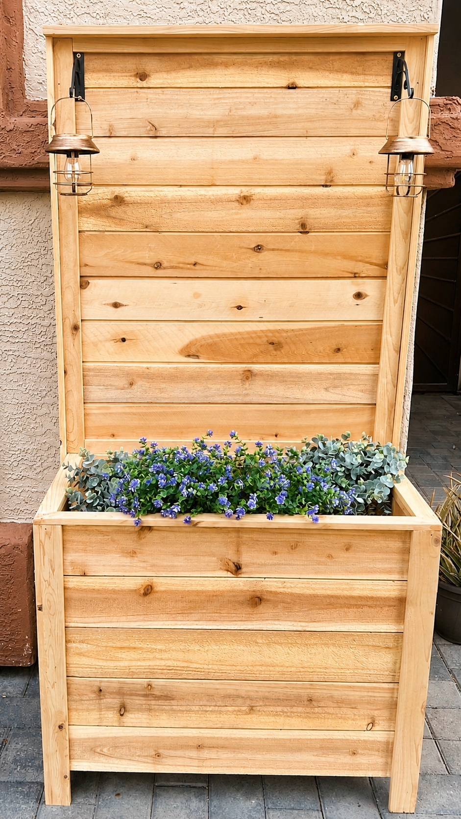 Rustic cedar planter box with a privacy panel and lanterns on a patio