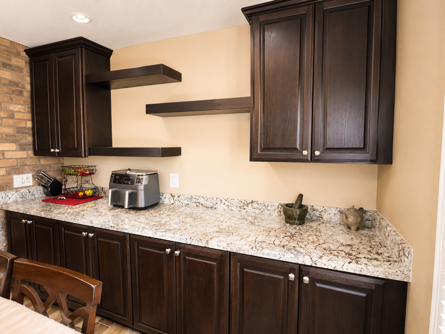 Dark walnut butler pantry cabinets with floating shelves and silver knobs