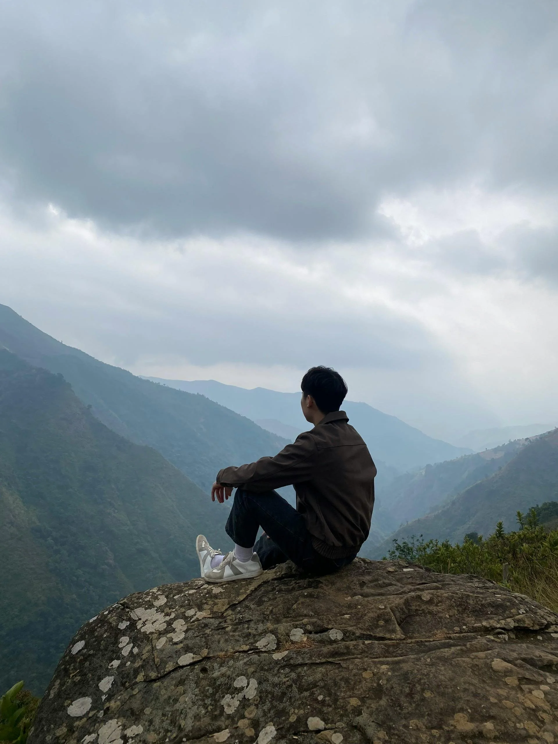 Man overlooking mountain valley reflection