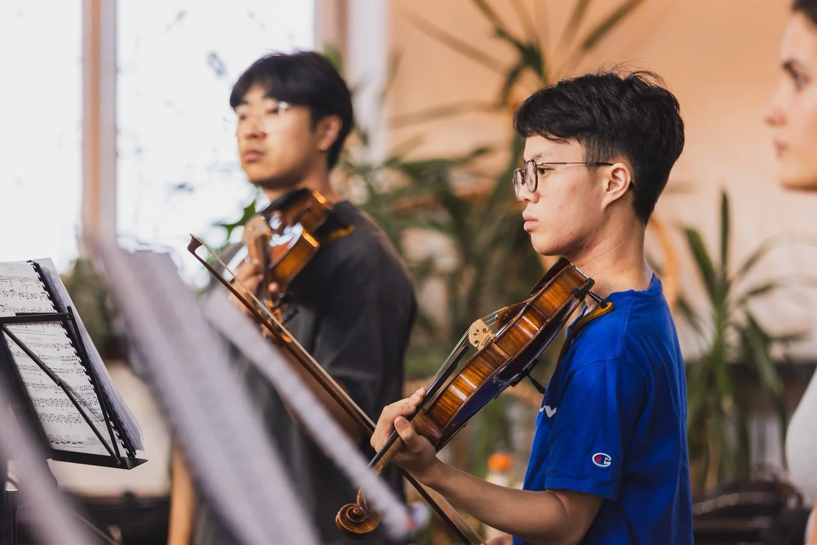 Violinists listening during rehearsal