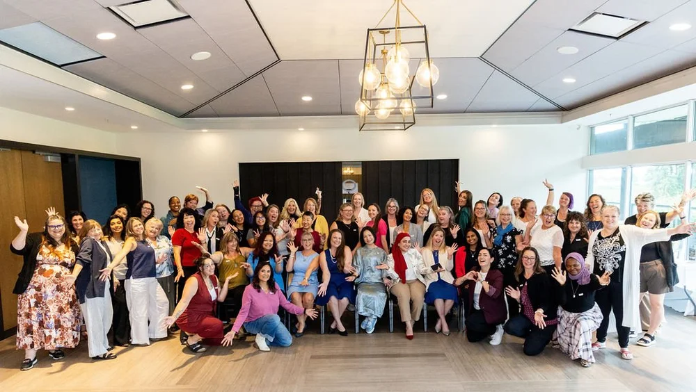 The full room cheering at a Female Forward Collective breakfast