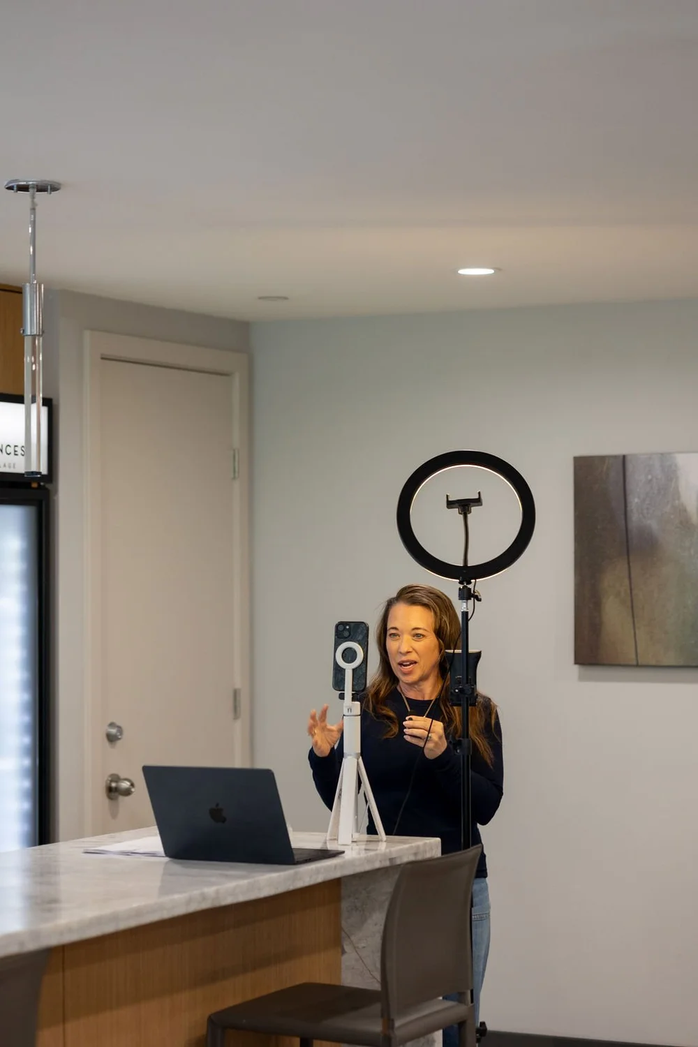 An attendee recording on her phone with a tripod and ring light