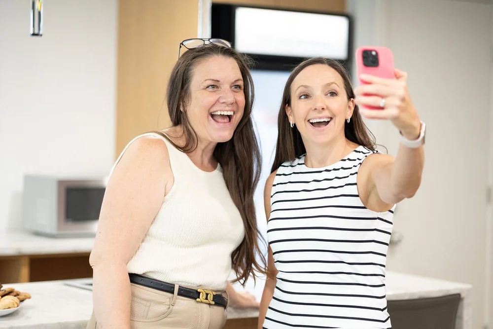 Two attendees recording a selfie video together