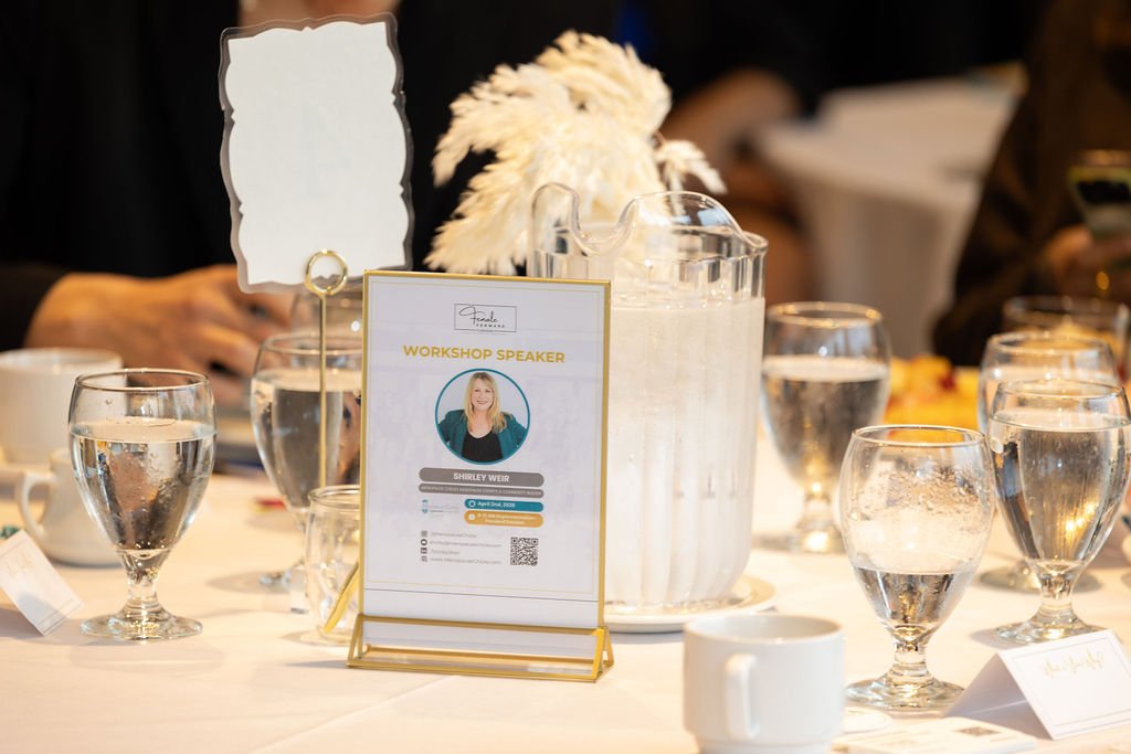 Table card announcing Shirley Weir as workshop speaker