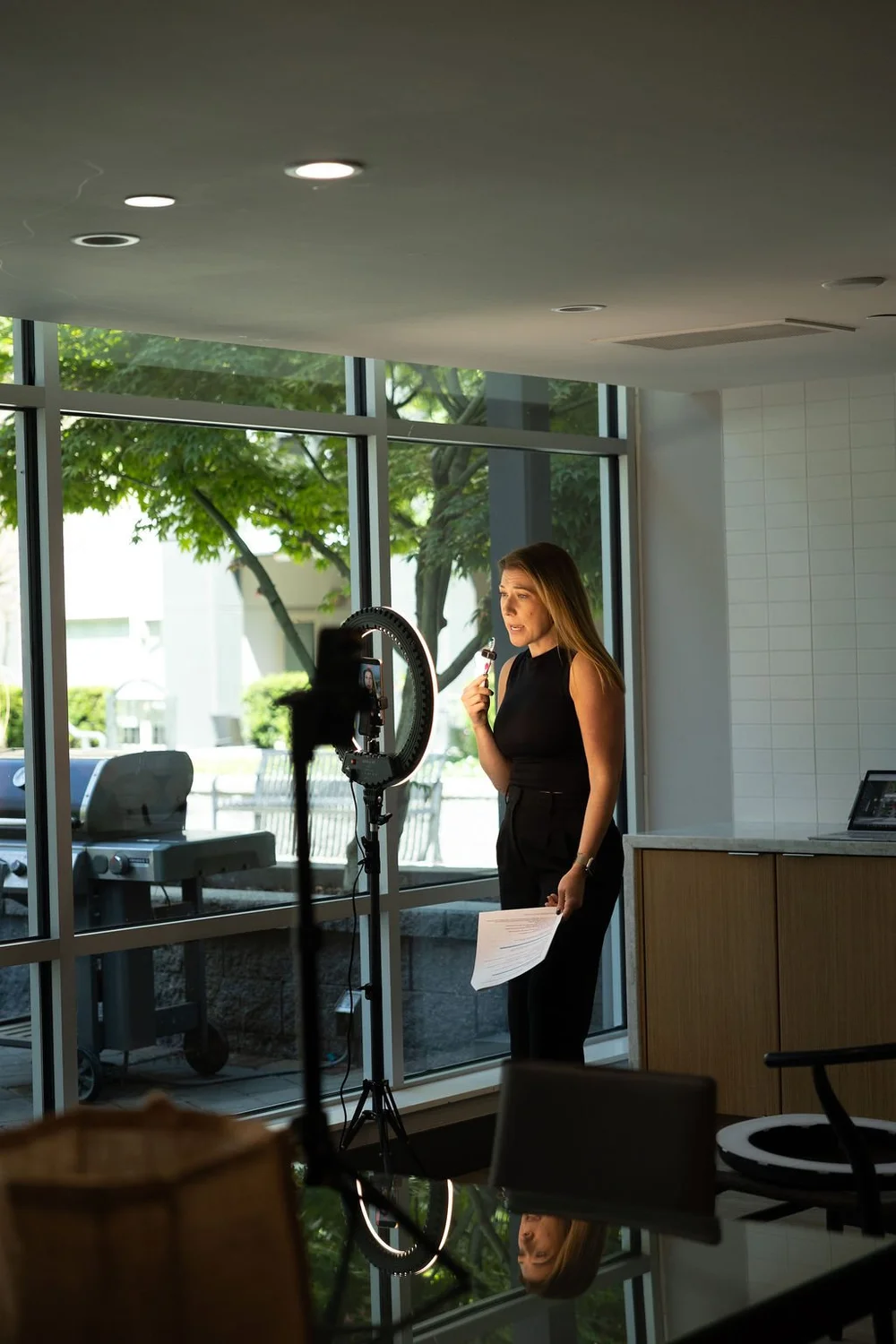 An attendee filming with a ring light, script in hand