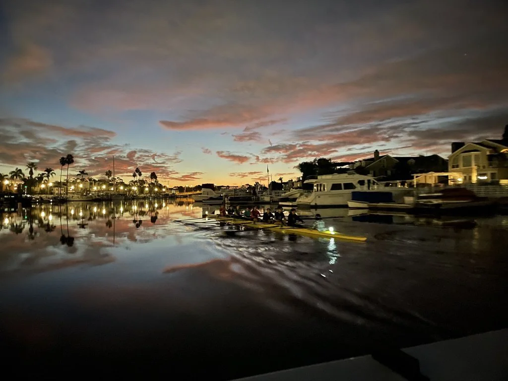 The women's crew row by eights around Naples Island.