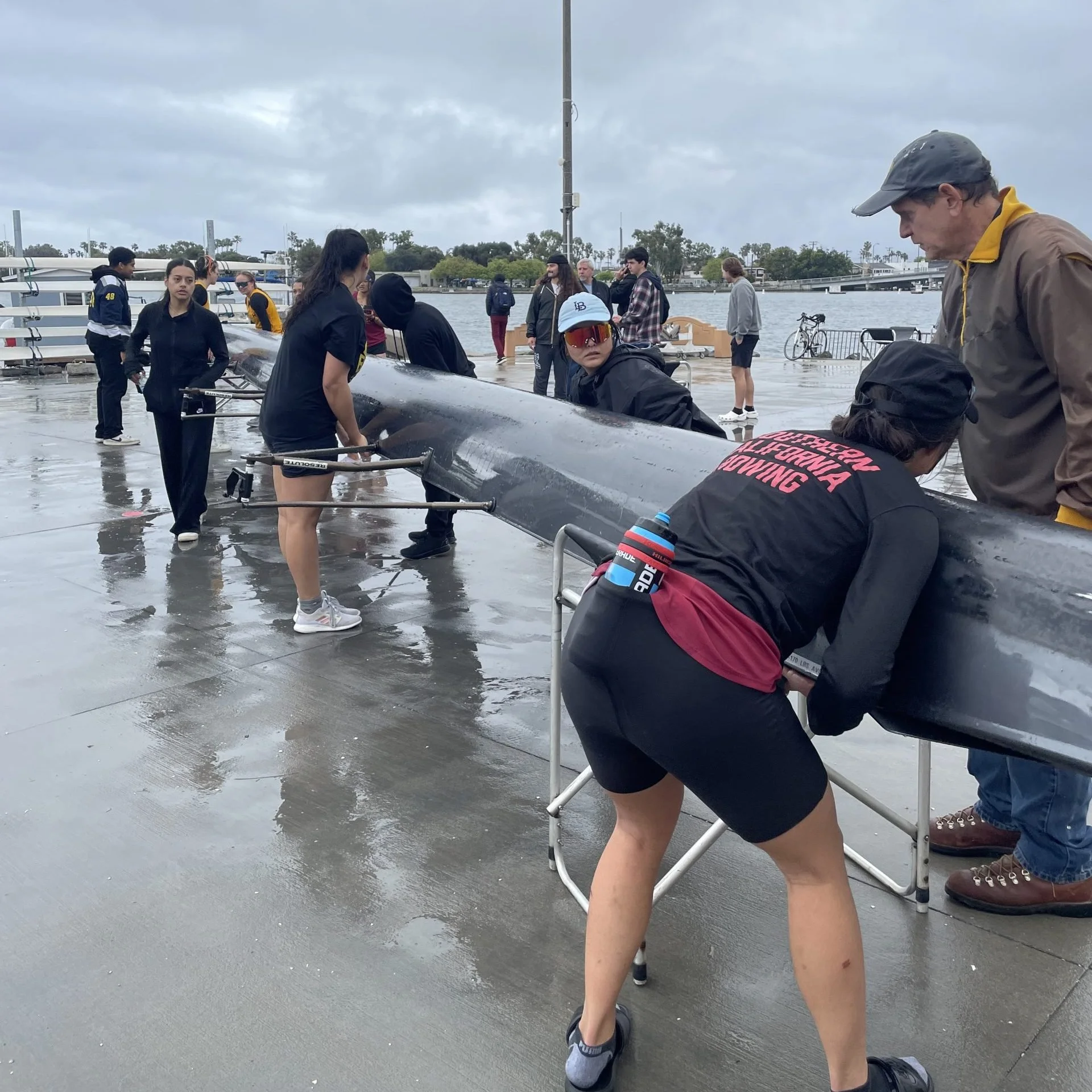 LBSU and USC putting their boat in stretchers.