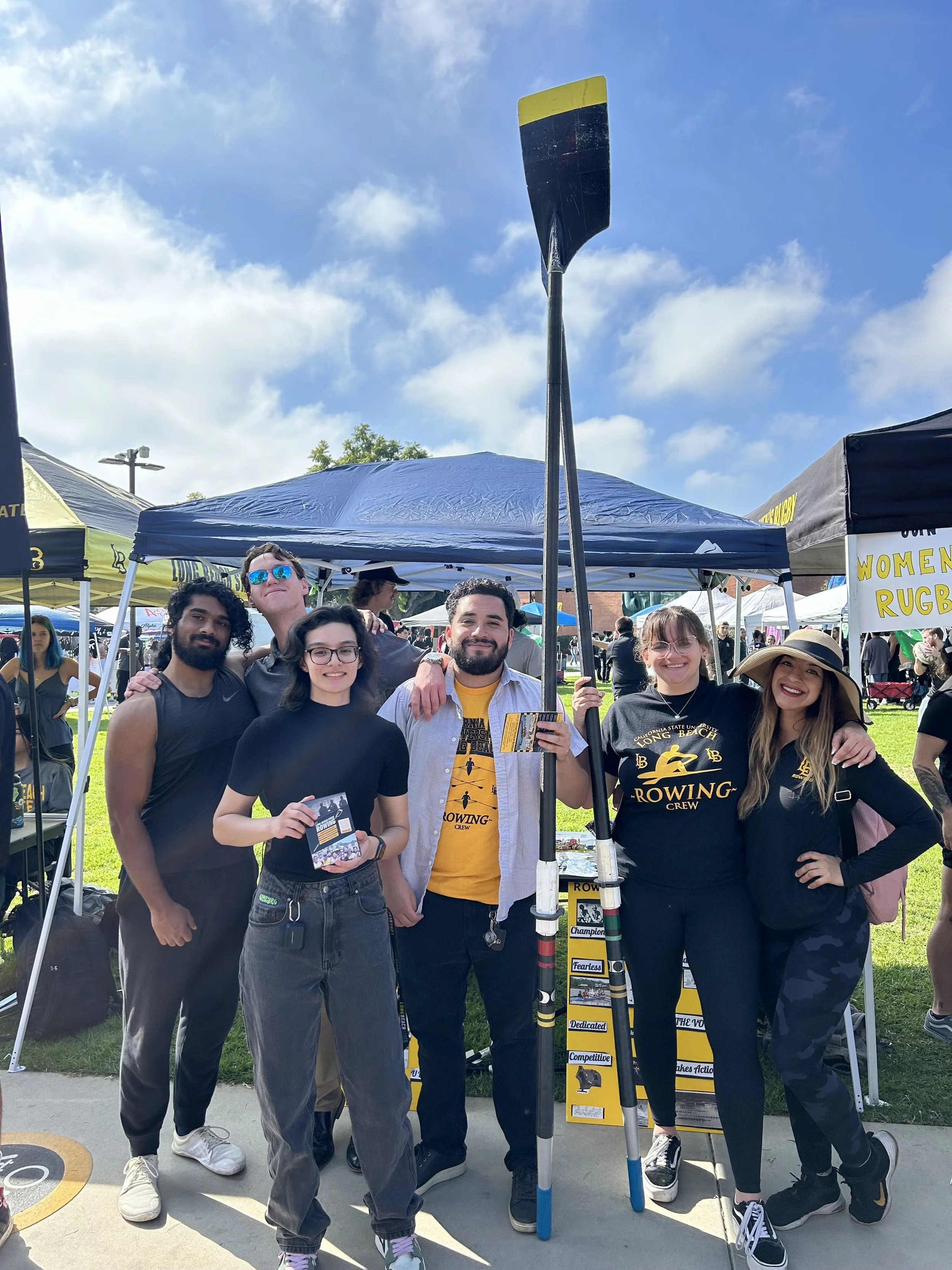 Victor Buen-Abad holds an oar while waiting to talk to passing students.