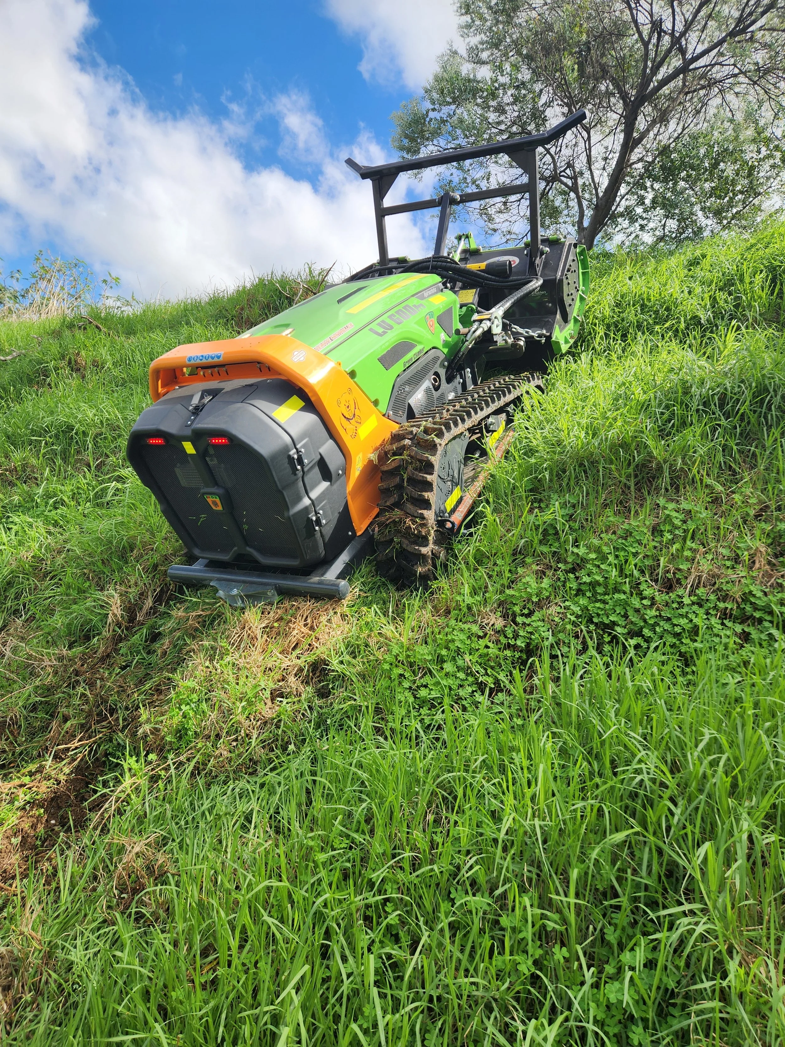 ARC11 remote-controlled mulcher climbing steep embankment — operator safely off hazard zone