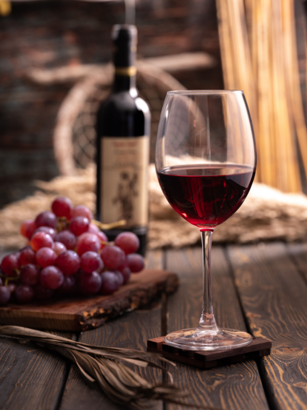 A glass of Barolo wine with tajarin pasta on a rustic table in Piedmont