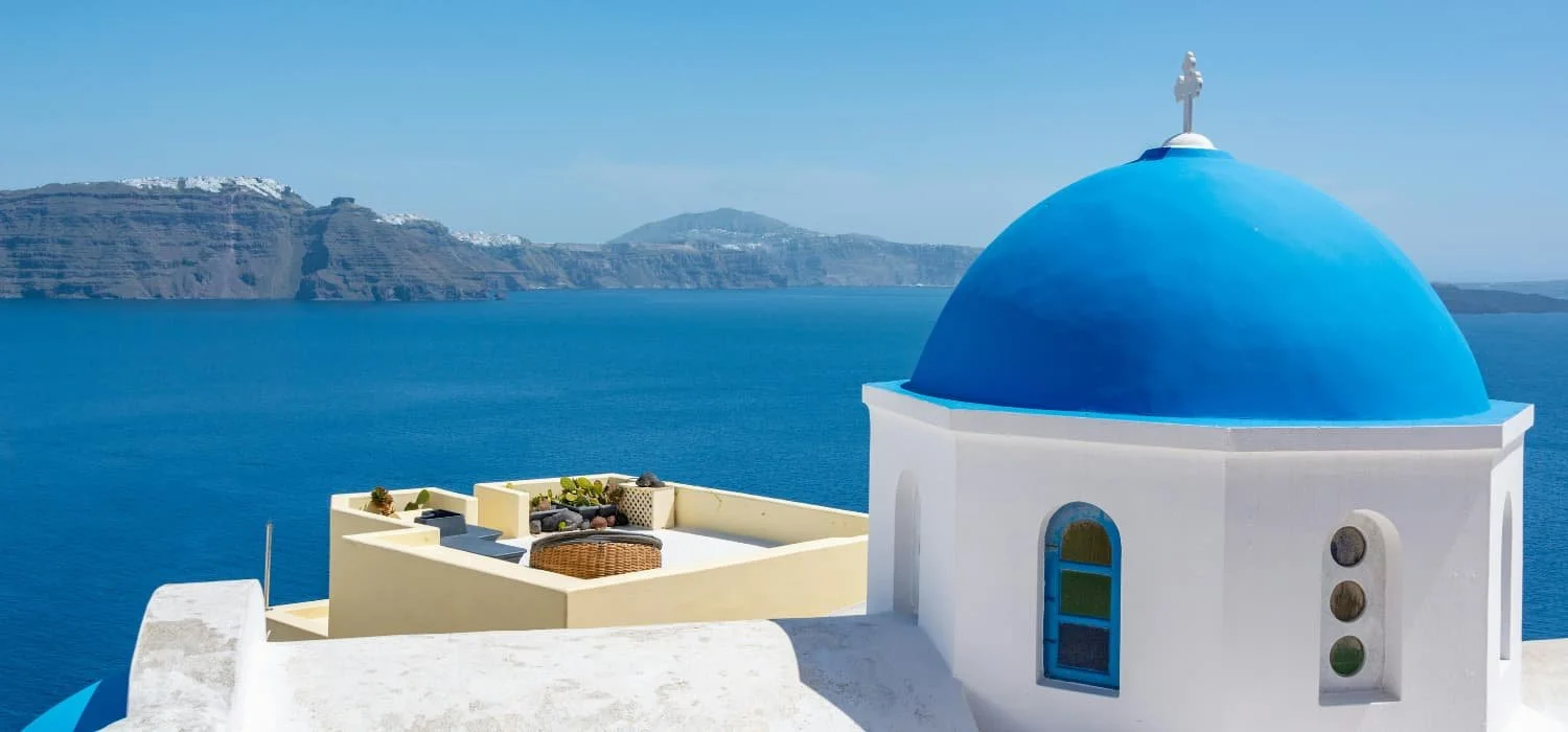 Greece honeymoon itinerary — Santorini caldera at dusk by The Itinerary Architect