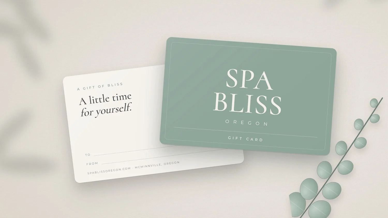 Spa Bliss Oregon gift card with a sprig of eucalyptus