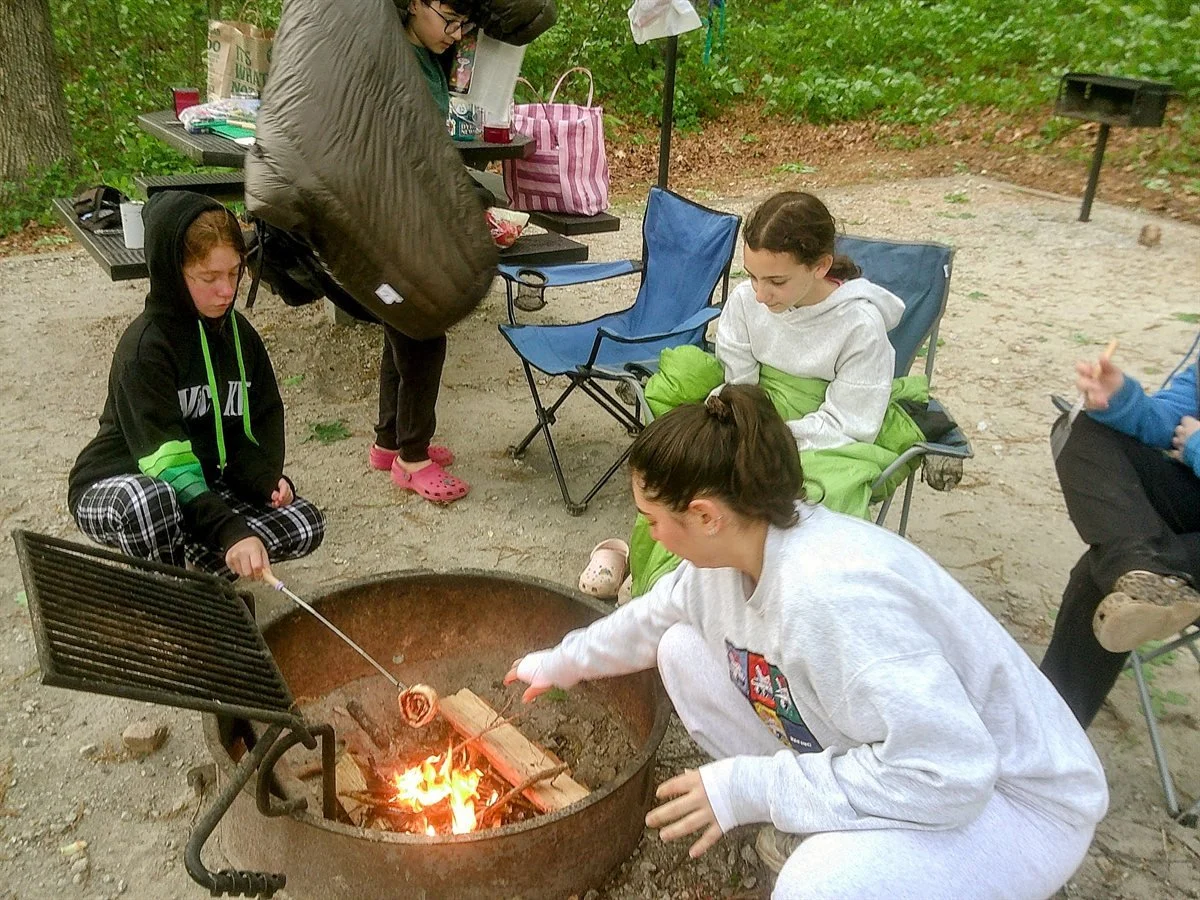 Cohort gathered around the campfire at the Shabbaton